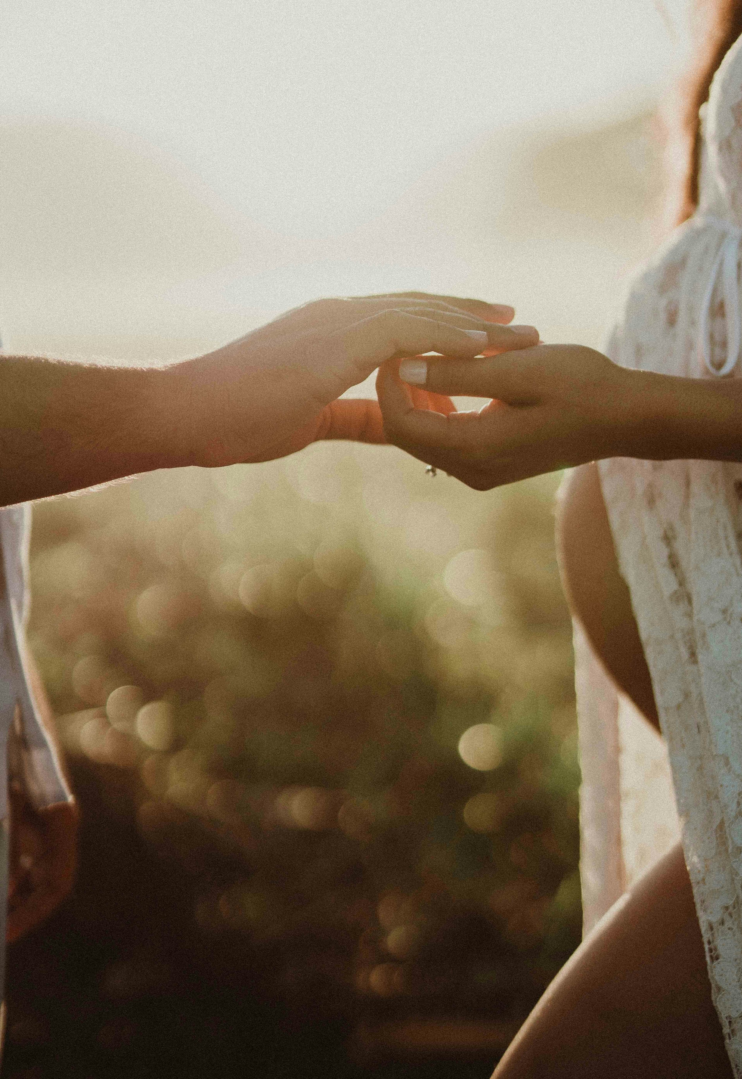 Partner's holding hands at  sunset, representing Motherwell's support for all types of births in Austin and Cedar Park, TX