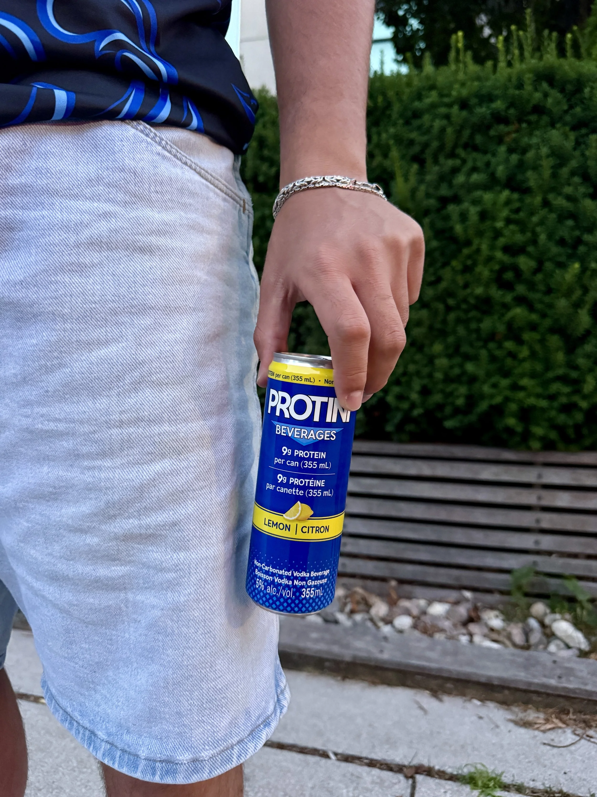 Several cans of Protini non-carbonated vodka beverage with lemon flavor inside a small fridge.