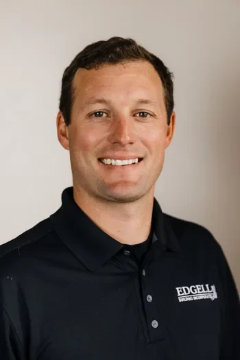 Jim James of Edgell Building. A young man with short brown hair smiling, wearing a navy blue polo shirt with a logo that says 'EDGELL' in white text.