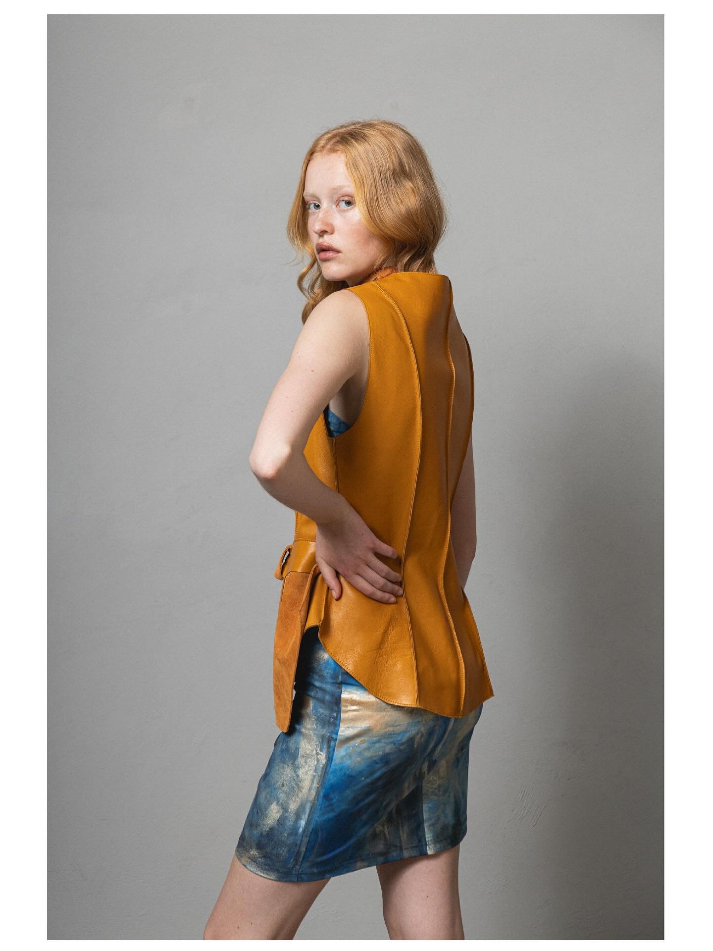 &ldquo;TERRA MODUS&rdquo; -Made to order 

Sculpted sleeveless leather vest with layered detailing contrasted with hand-painted strapless lycra dress. 

Build to last beyond the seasons . 

Photography @bubblyblably 
Make up / hair @ksakkas 
Model @e