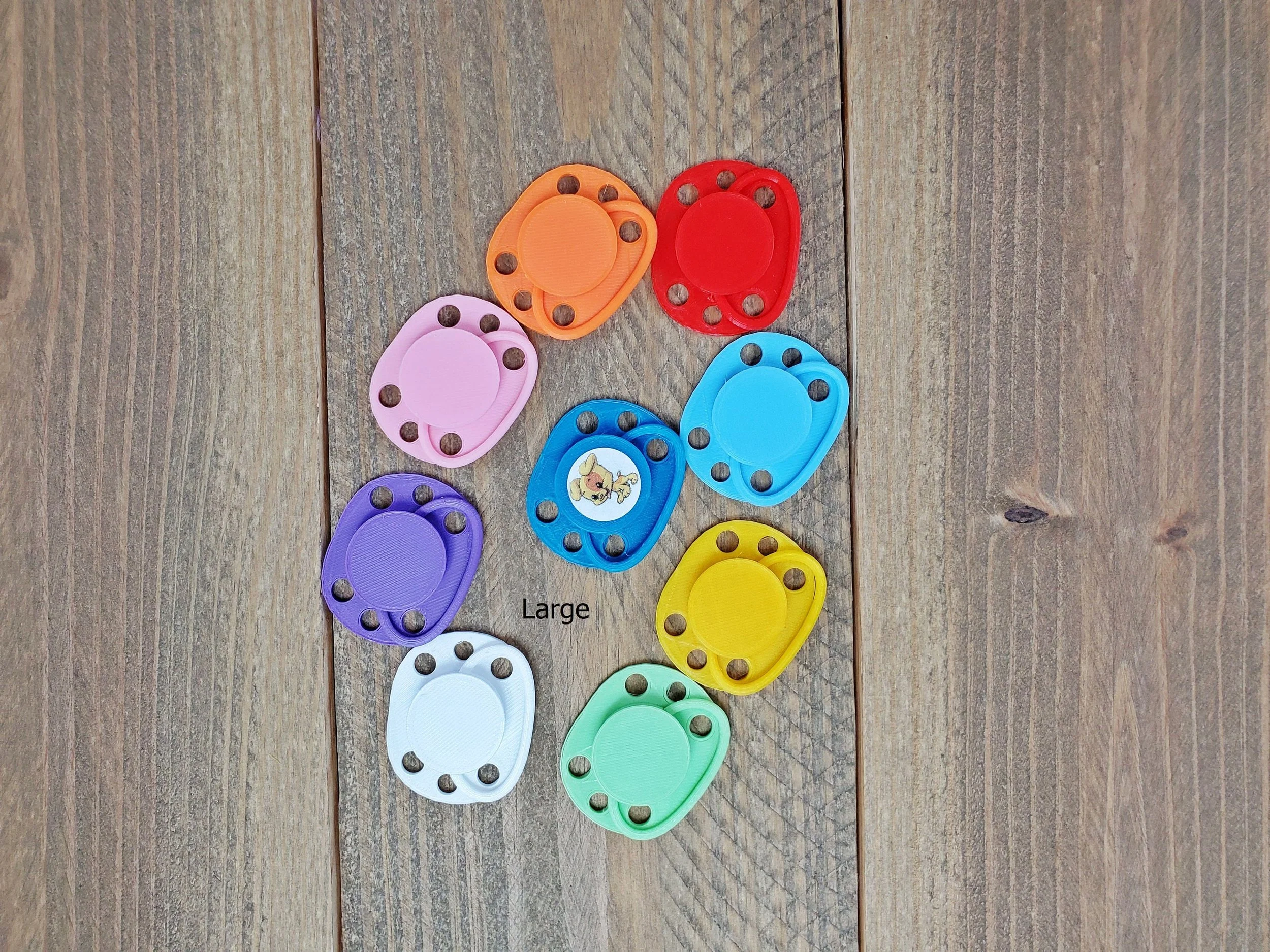 Magnetic doll pacifier with stickers