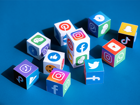 Colorful cubes displaying popular social media platform logos representing OC Videography’s expertise in social media video production and digital content creation.