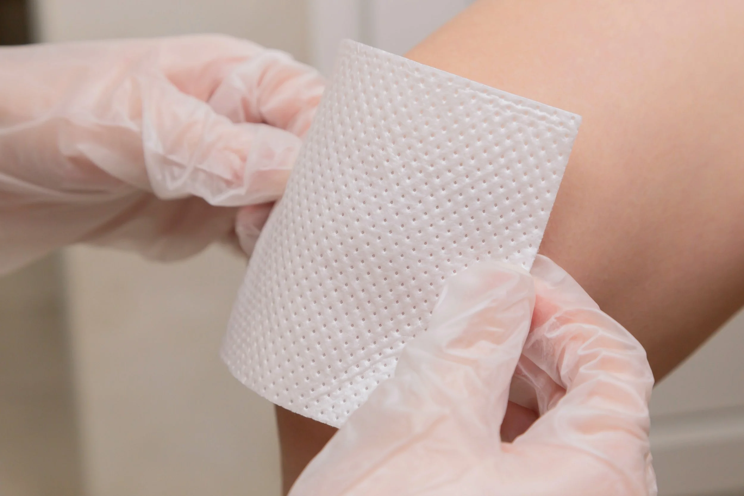 Photo of a doctor treating a knee wound