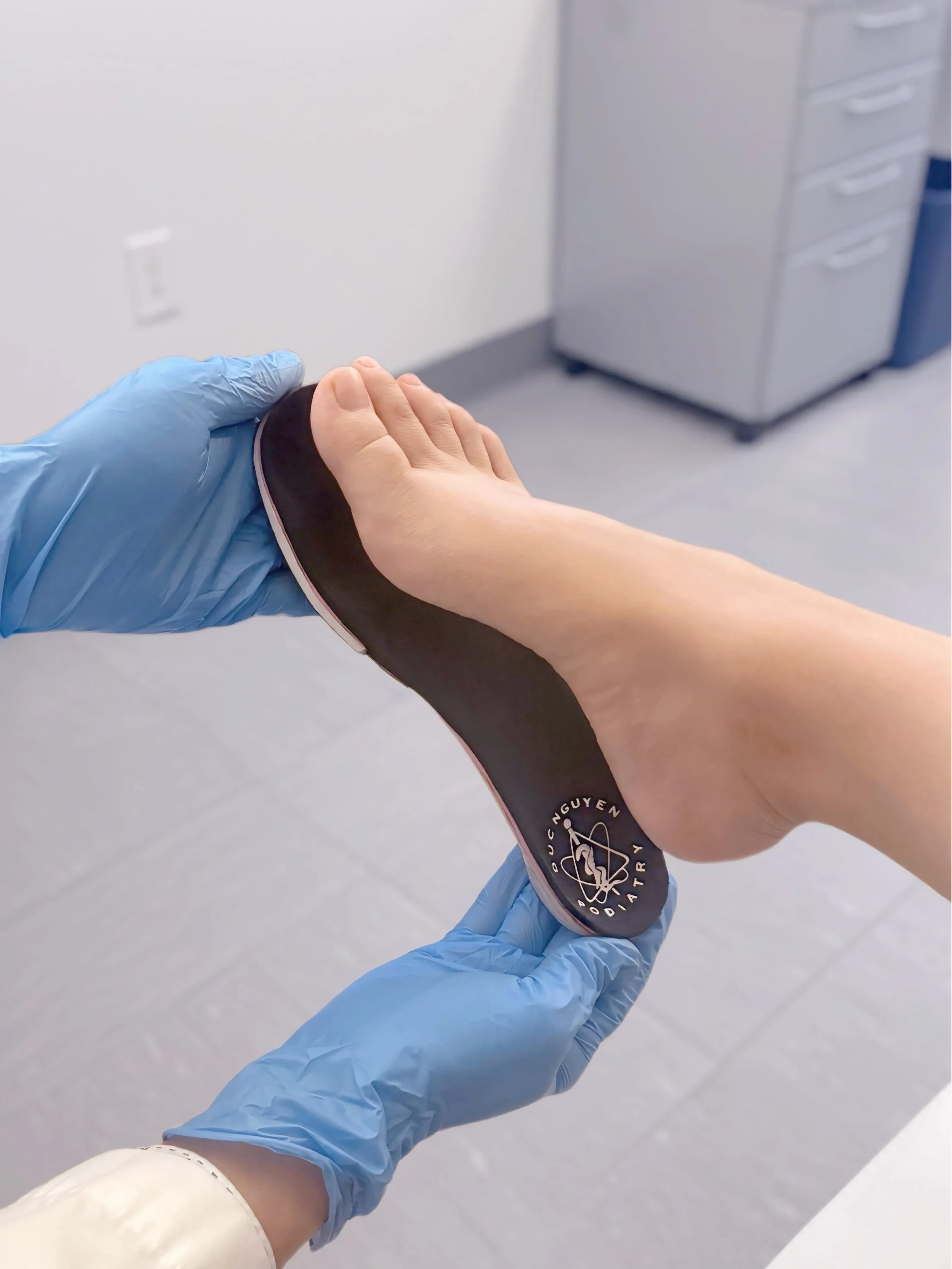 Photo of a doctor handling feet orthotics