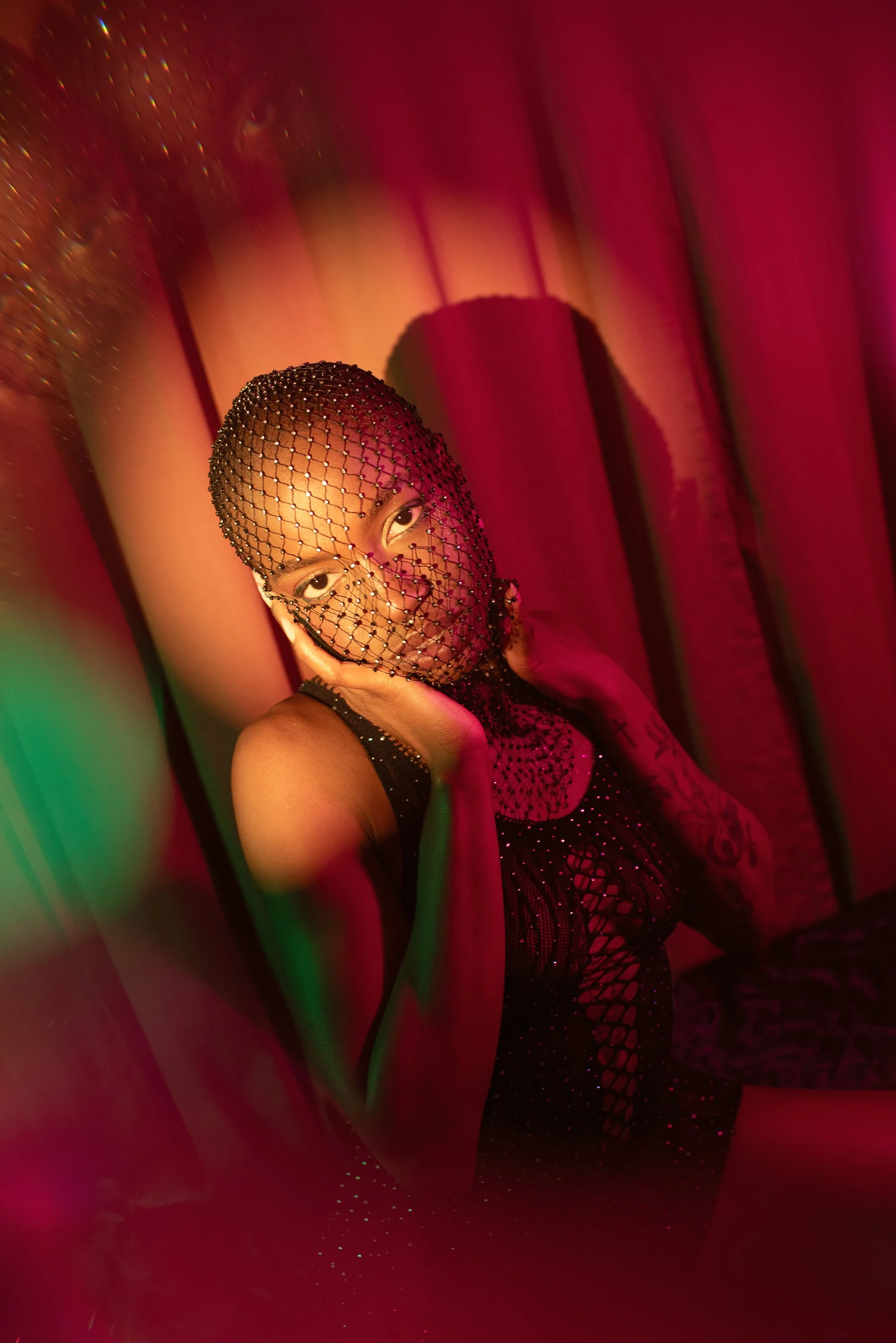Boudoir Neon session with Djau, showcasing bold lighting and elegant pose.