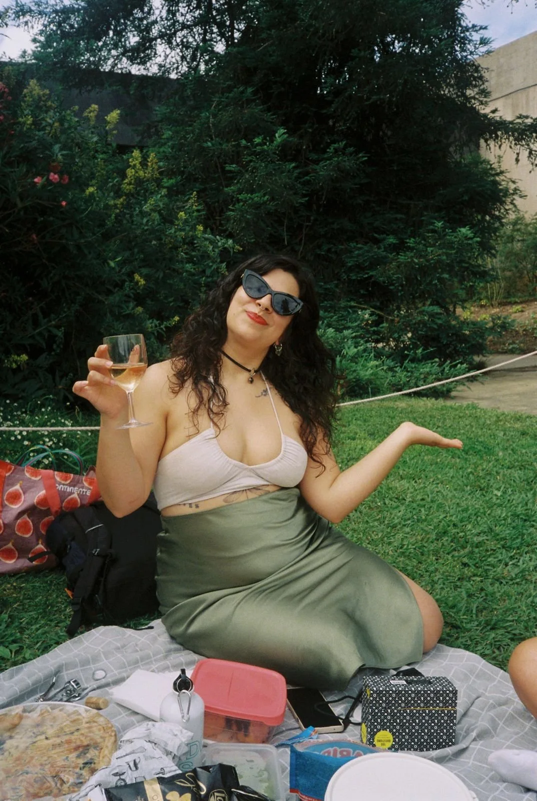A woman with long curly hair in a picknic scene