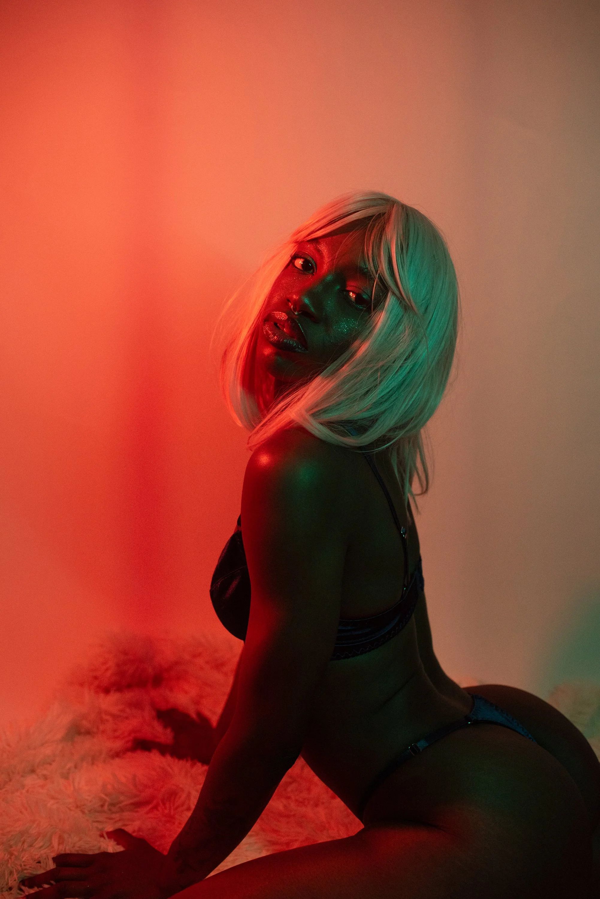 Boudoir Neon session with Djau, showcasing bold lighting and elegant pose.