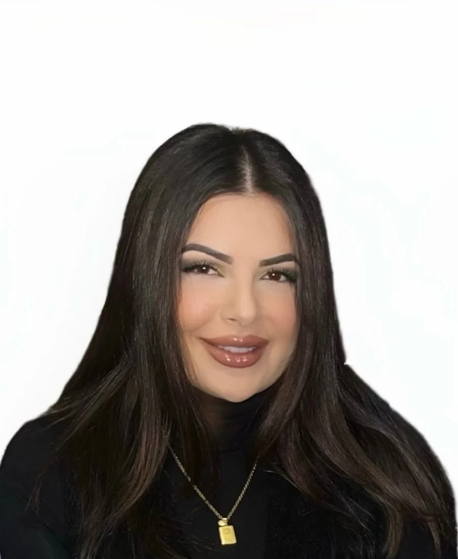 Close-up of a blooming pink water lily flower against a blurred, warm-toned background.