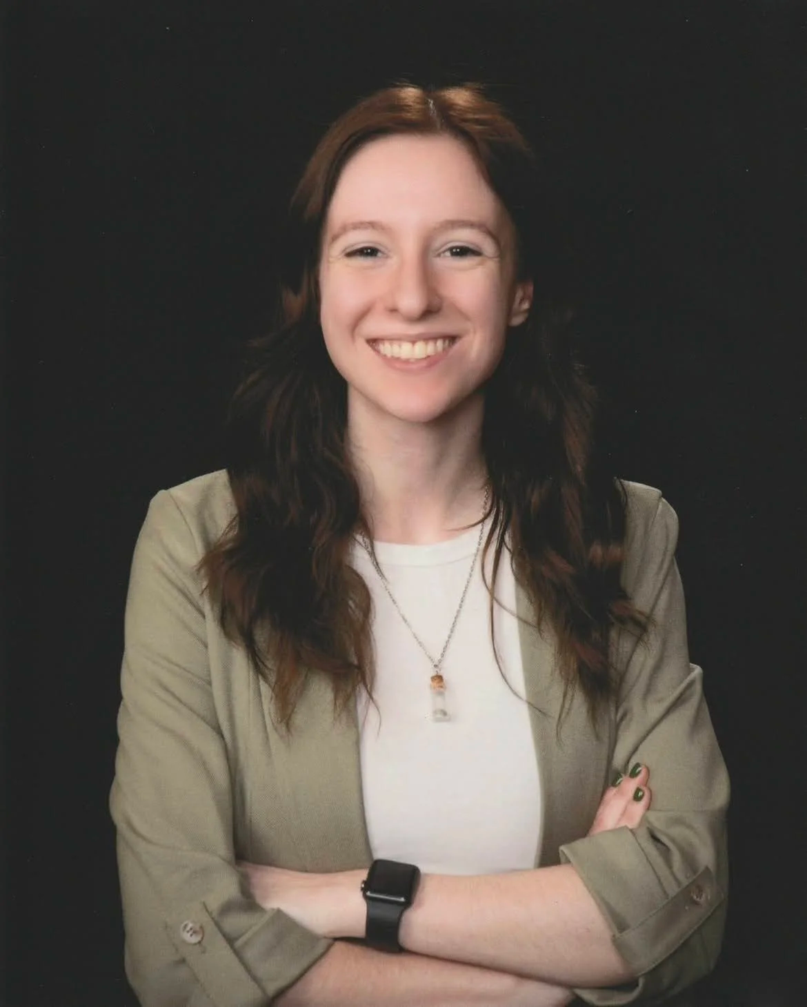 Two hands form a heart shape around a pair of seashells with a cloudy sky in the background.