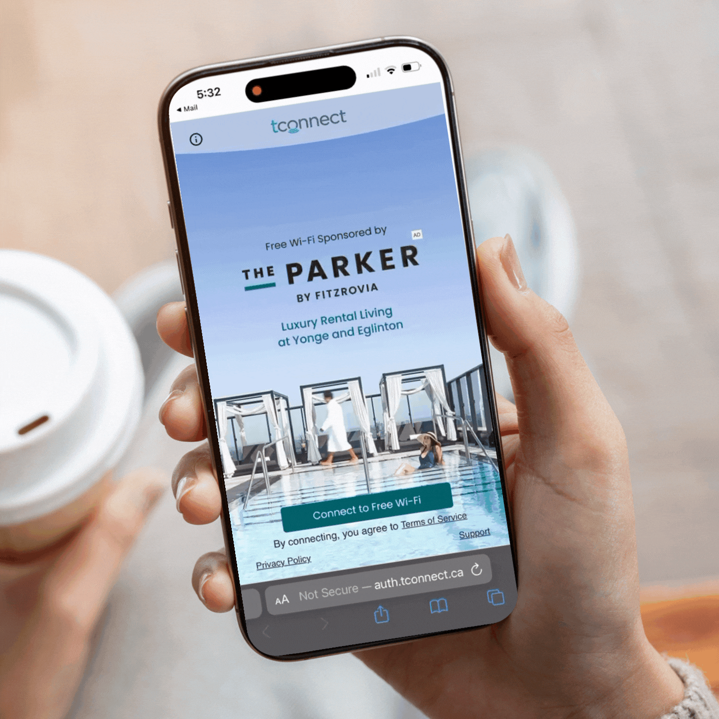 A person holding a smartphone displays a Wi-Fi login page titled 'tconnect' for free Wi-Fi at 'The Parker by Fitzrovia,' showing an outdoor pool area with cabanas.