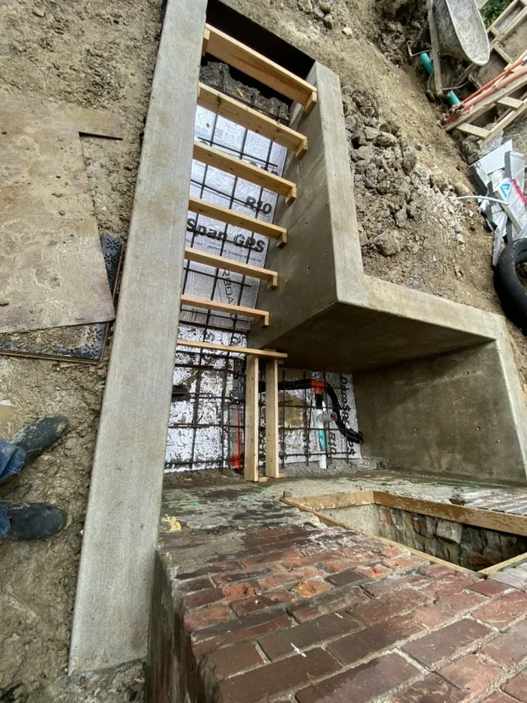 Foundation work on a staircase with concrete steps and wooden supports for future construction.
