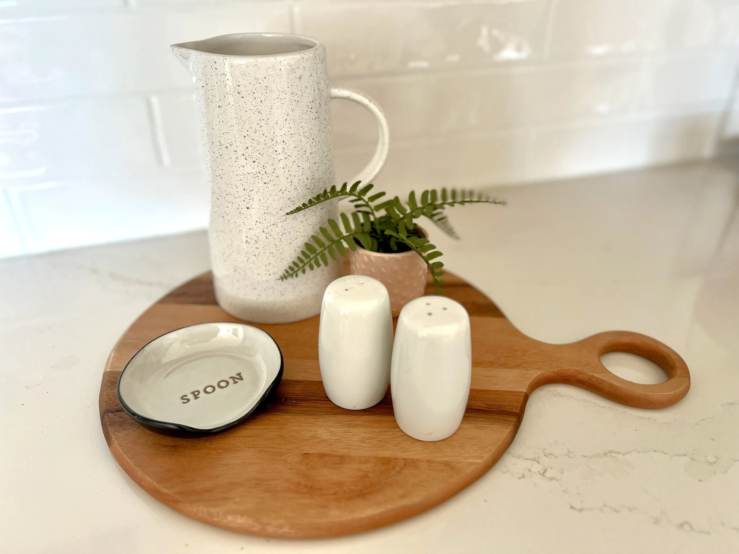 Use pretty cutting or serving boards to anchor frequently used items.