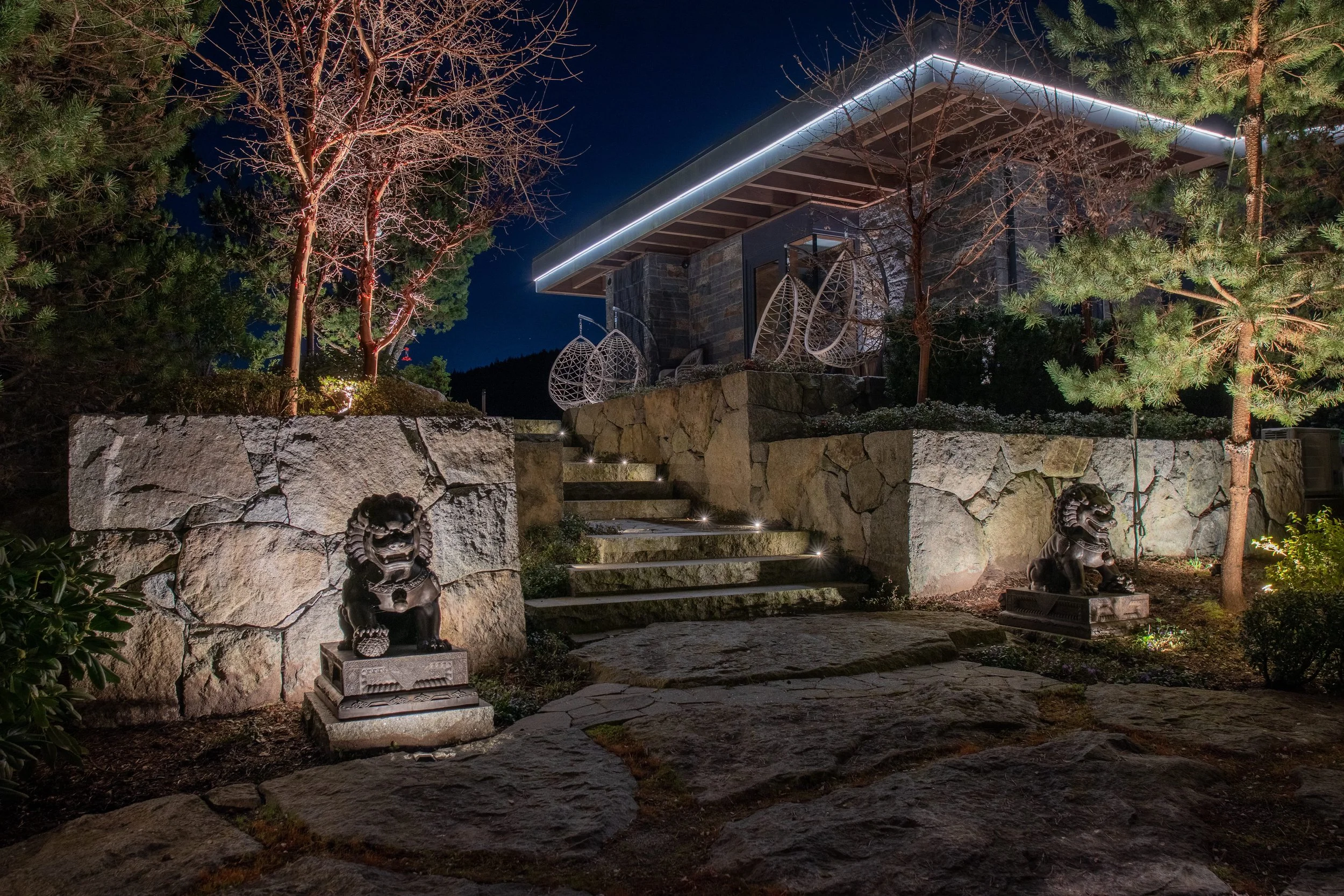 landscape lighting on rock face and statue