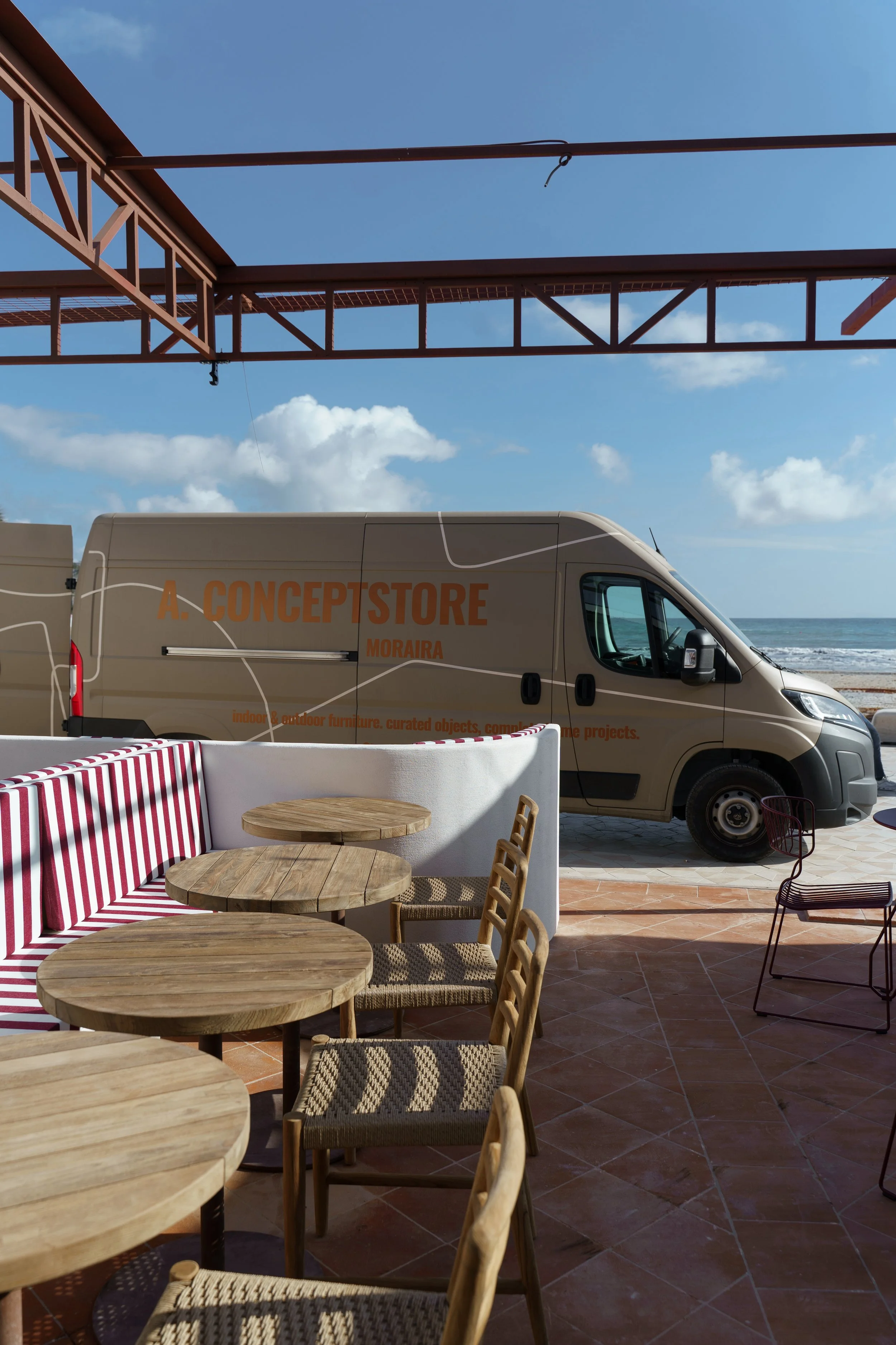 Installation picture off our van with logo in Pluk Spain Javea on the Arenal. Where A concept store moraira did a full interior and exterior project. Consulting of the renovation project, furniture delivery and curation and installation of furniture.