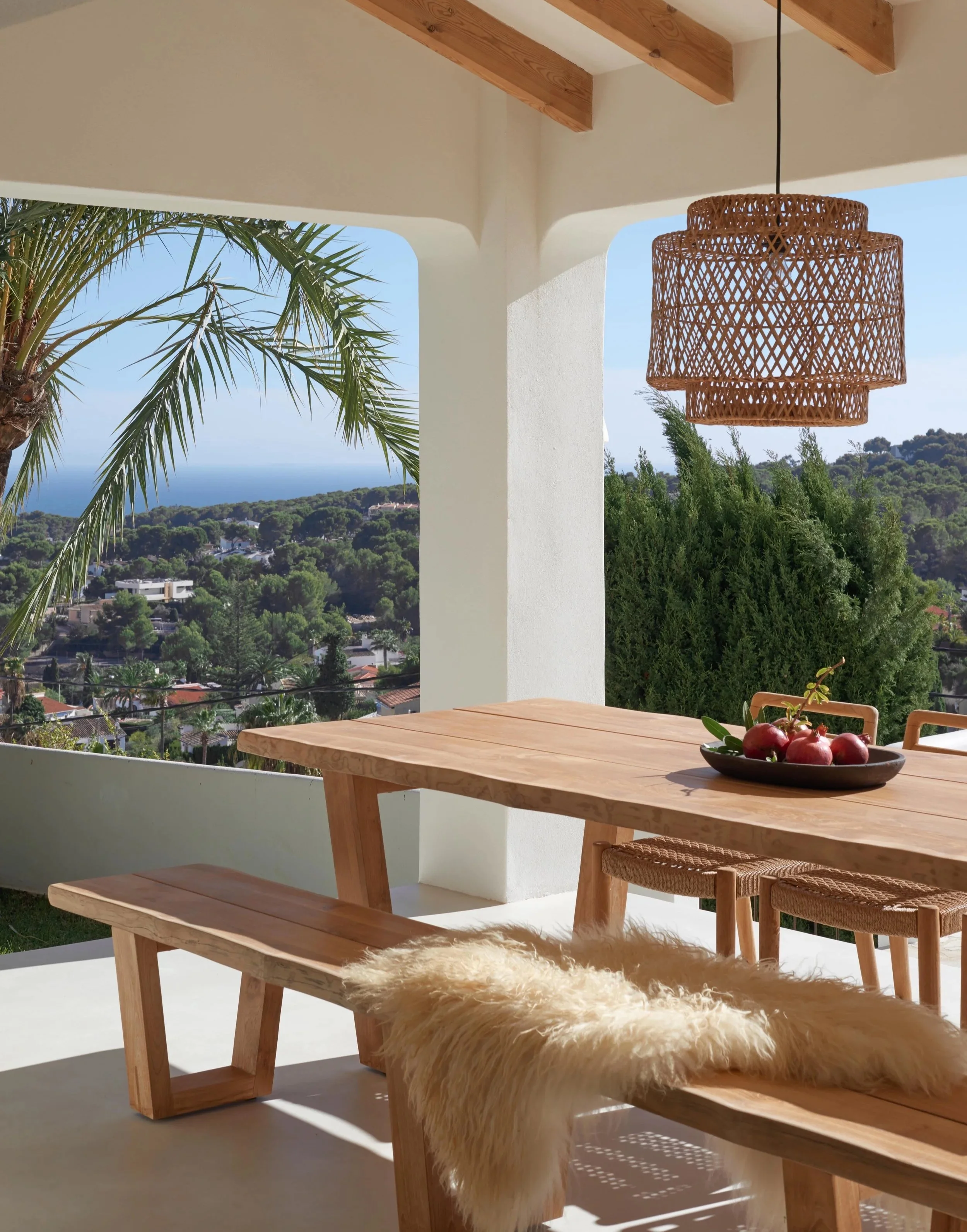 Full renovation project and interior design. We furnished it with outdoor teak furniture to eat outside with a sea view, decorated with sheepskin and a hanging lamp. 