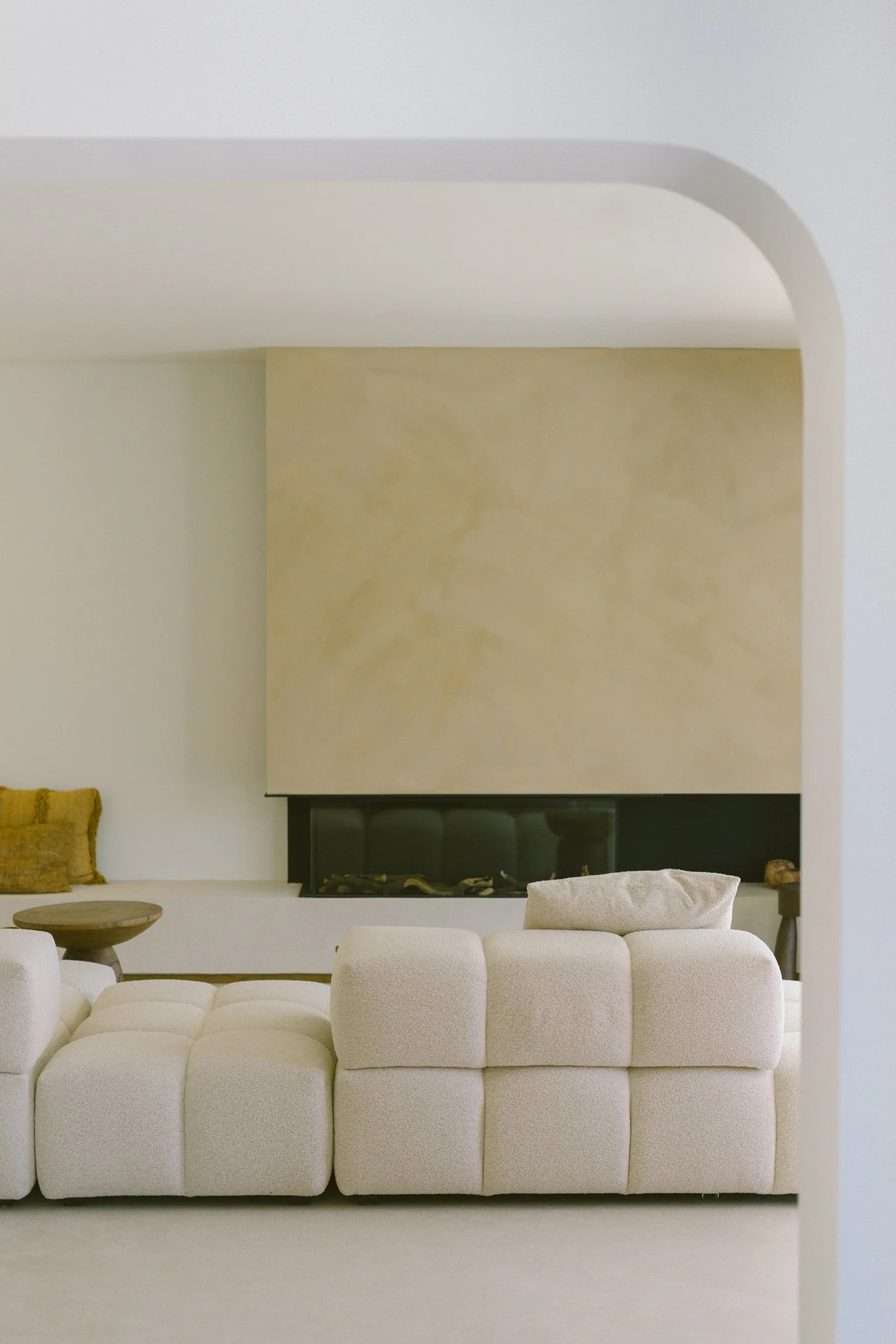 Modern living room with beige element sofa, a fire place, and minimal decor. All from our full interior projects 