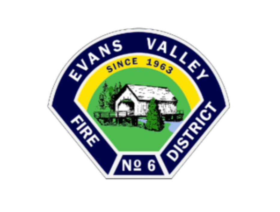 Evan's Valley Fire District badge with a house and trees illustration in the center, surrounded by blue and yellow borders, indicating 'Since 1963' and 'No 6'.