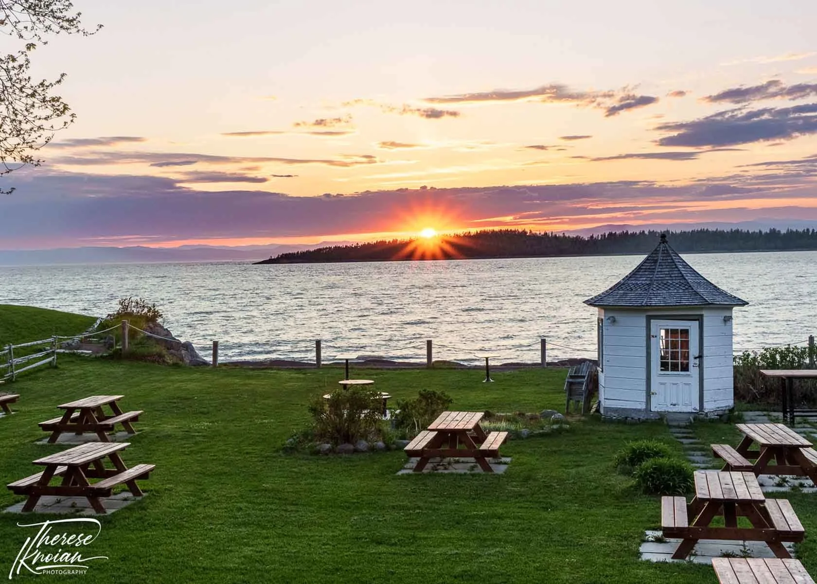 A sunset with sunburst on the St Lawrence River at Cote Est restaurant in Kamouraska.