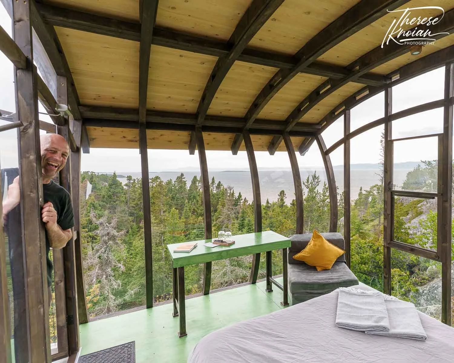 Looking out at the amazing view of a perch at Perchoir du Cirque with a smiling owner Elyme Gilbert looking in the door