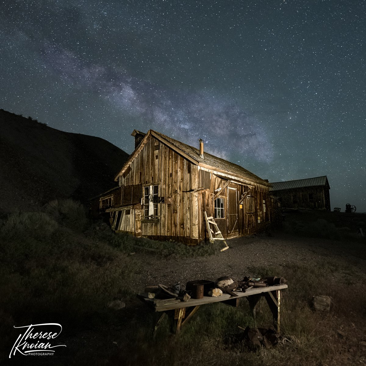 In the Berlin Ghost Town, a light-painted historic structure with the Milky Way overhead