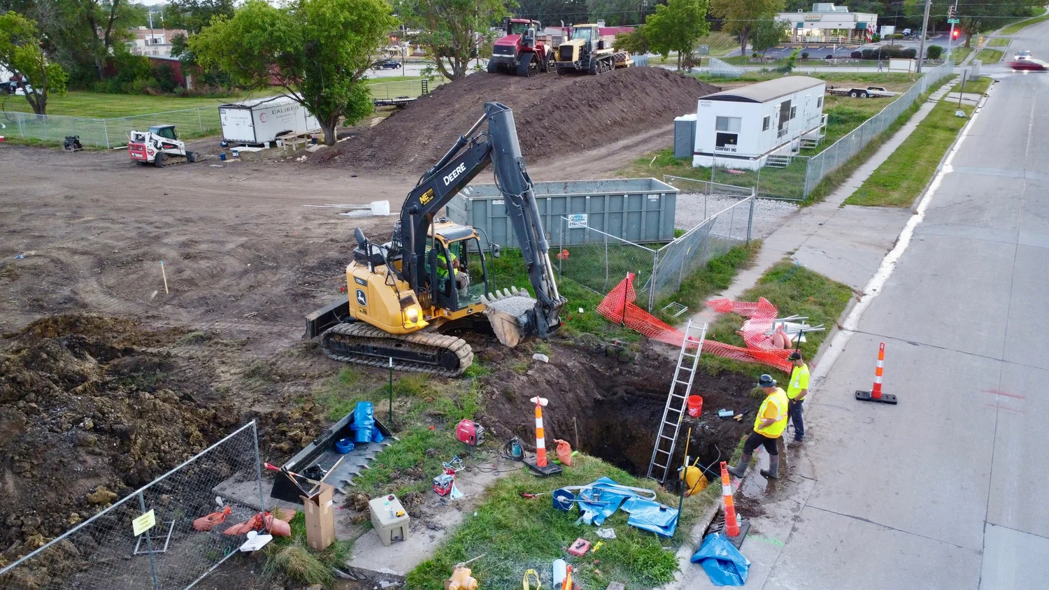 Excavator and crew working on an underground utility project