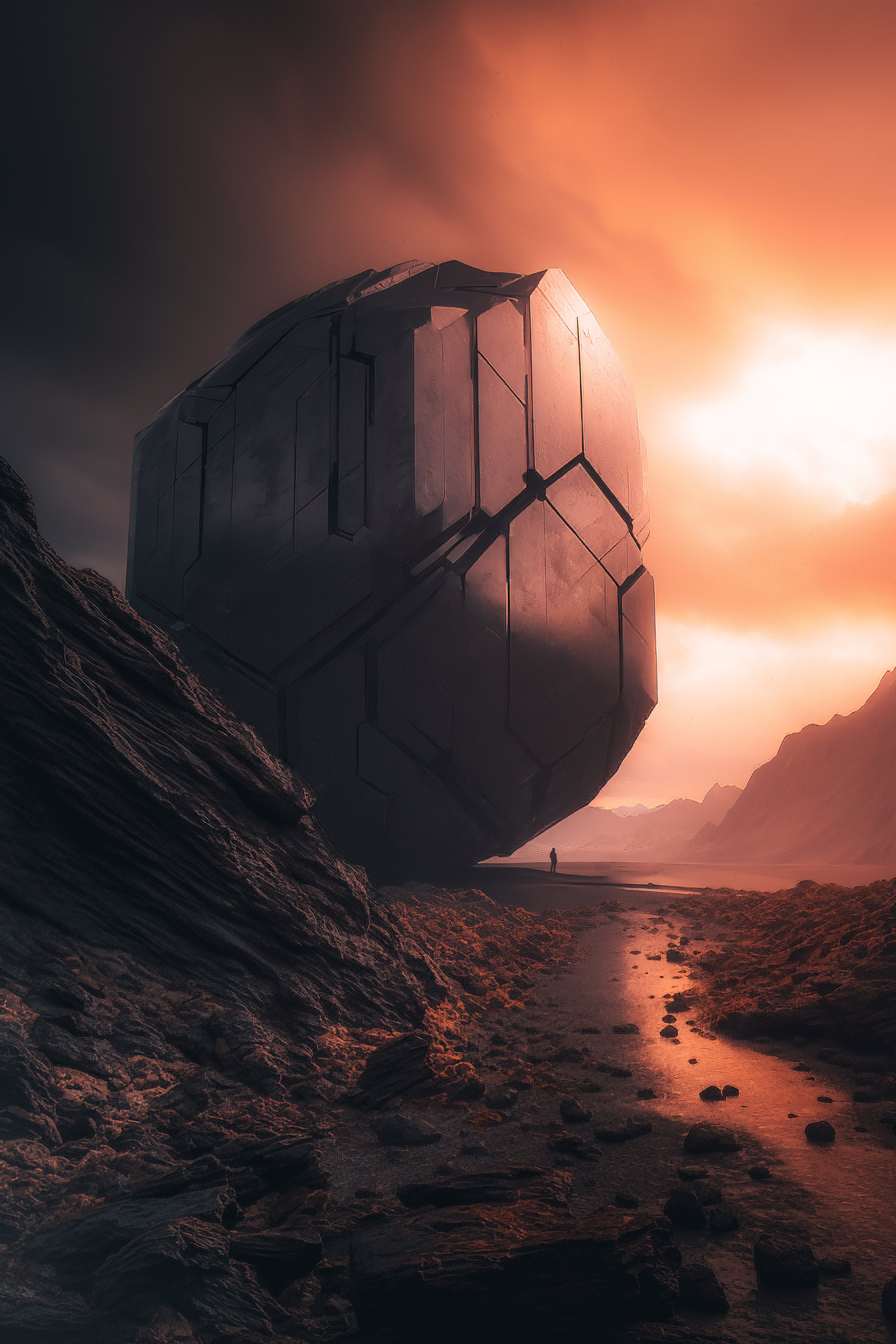 A large, futuristic, hexagon-shaped structure situated in a barren, rocky landscape with mountains in the background and an orange sky.