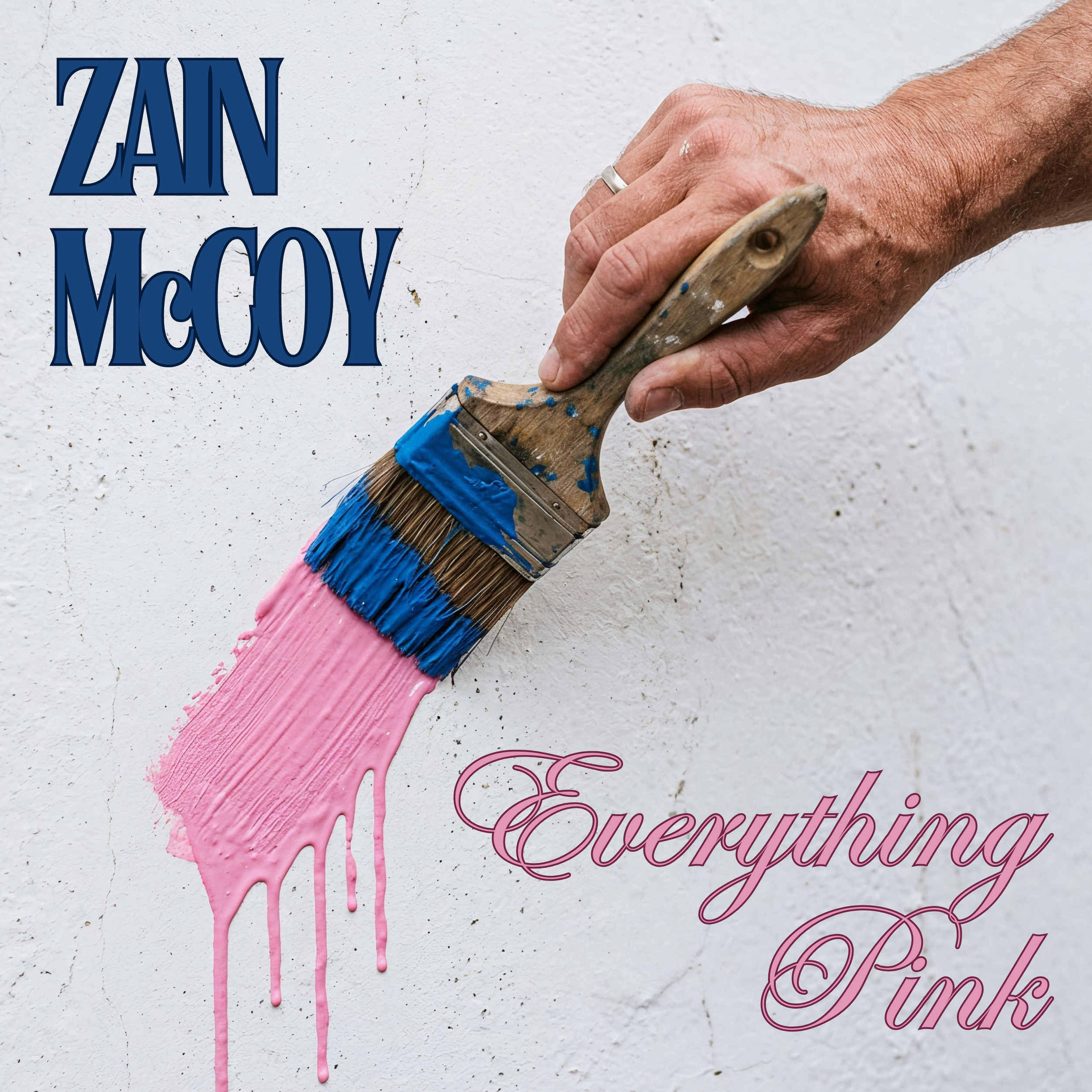 A person holding a paintbrush with blue paint on the bristles, painting pink on a white wall that says 'Zain McCoy' and "Everything Pink" with a decorative cursive style.