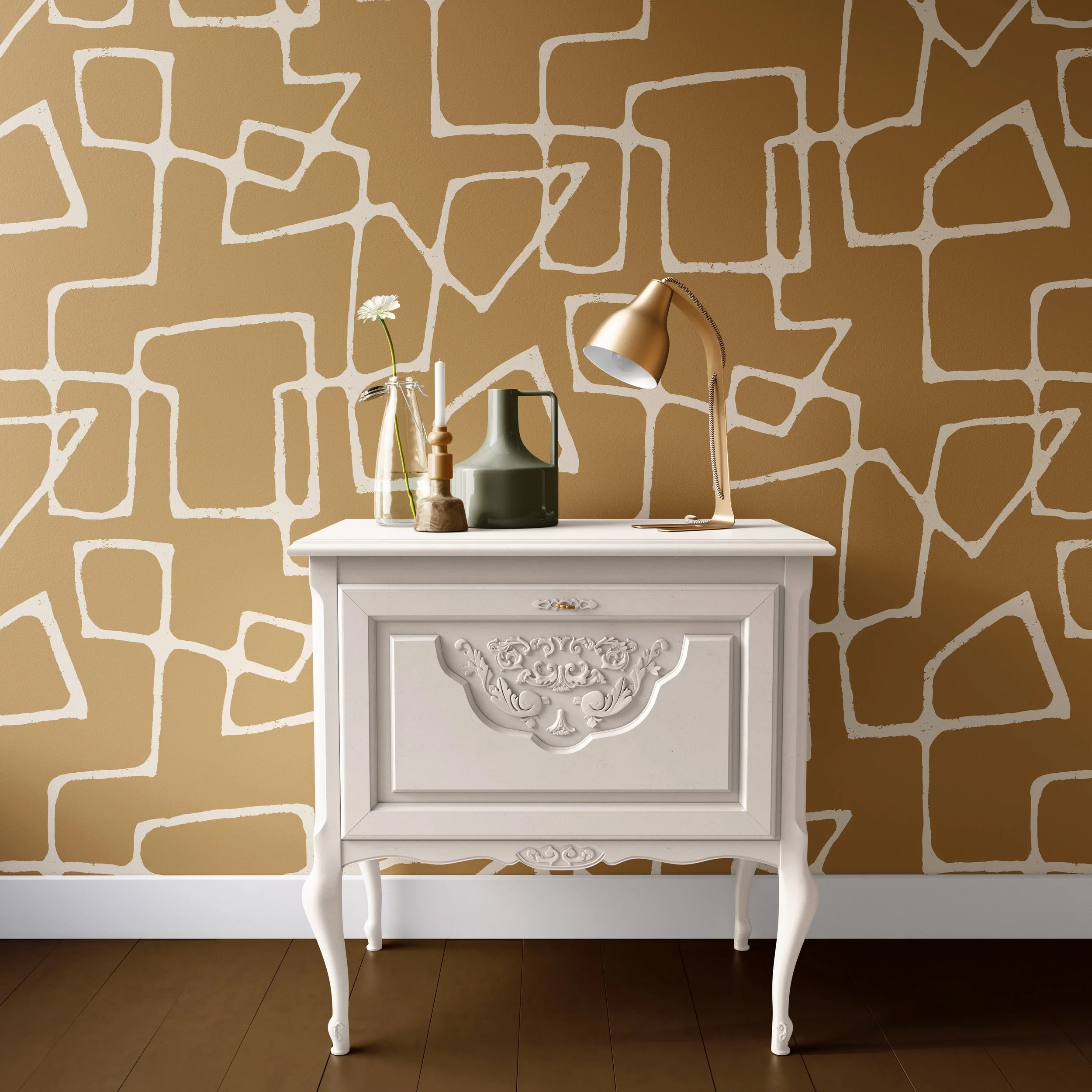 White ornate table with vases and a lamp against a wall with a mid-century modern geometric patterned wallpaper with off-white lines on a deep yellow background..