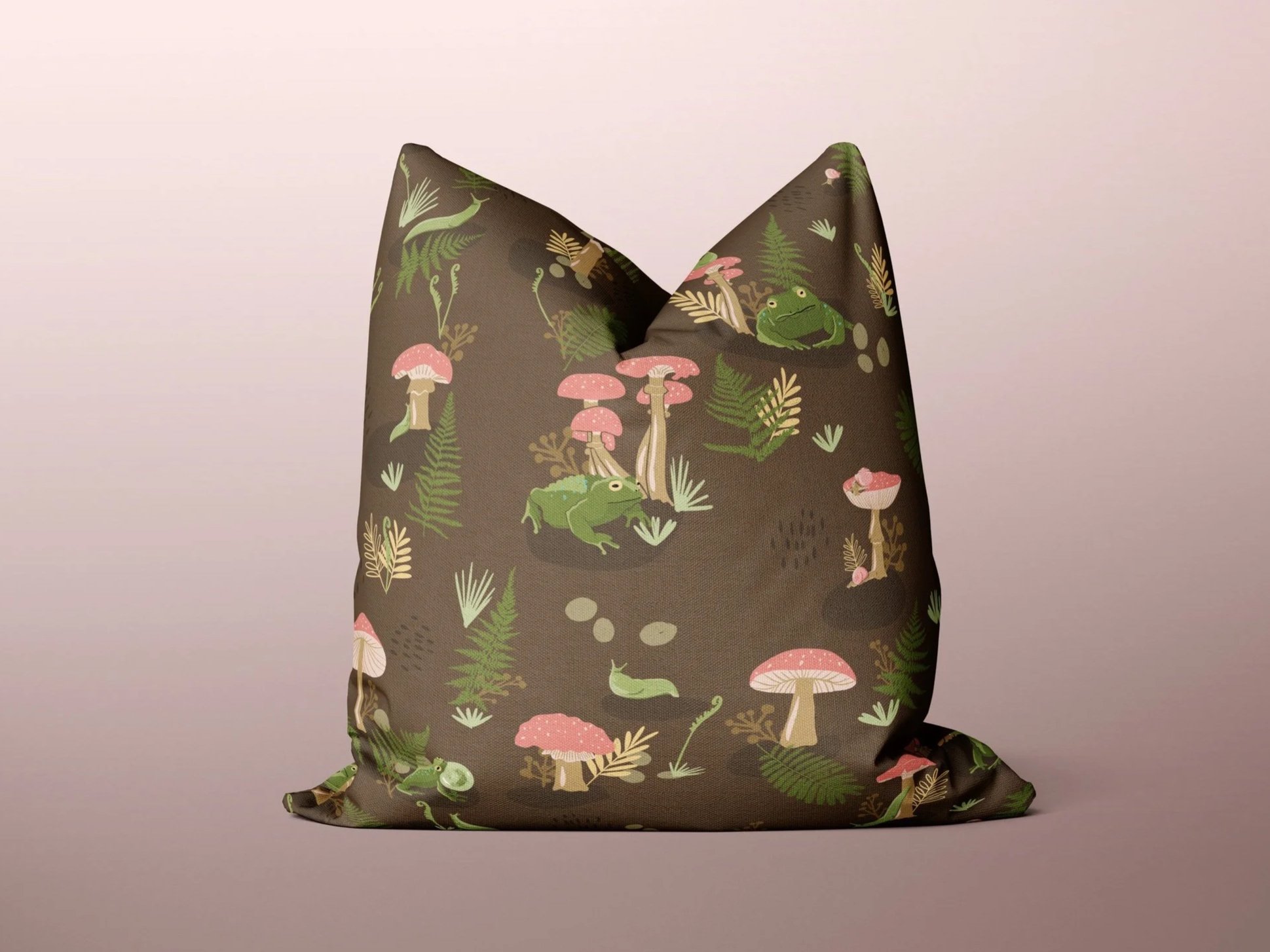 Fabric bag with a nature-themed pattern featuring frogs, mushrooms, and various plants on a brown background.