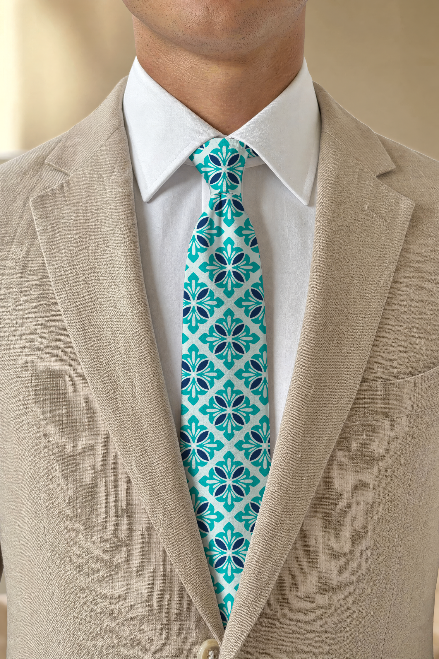 Close-up of a man's neck, wearing a light beige suit jacket, white dress shirt, and a blue floral patterned tie.