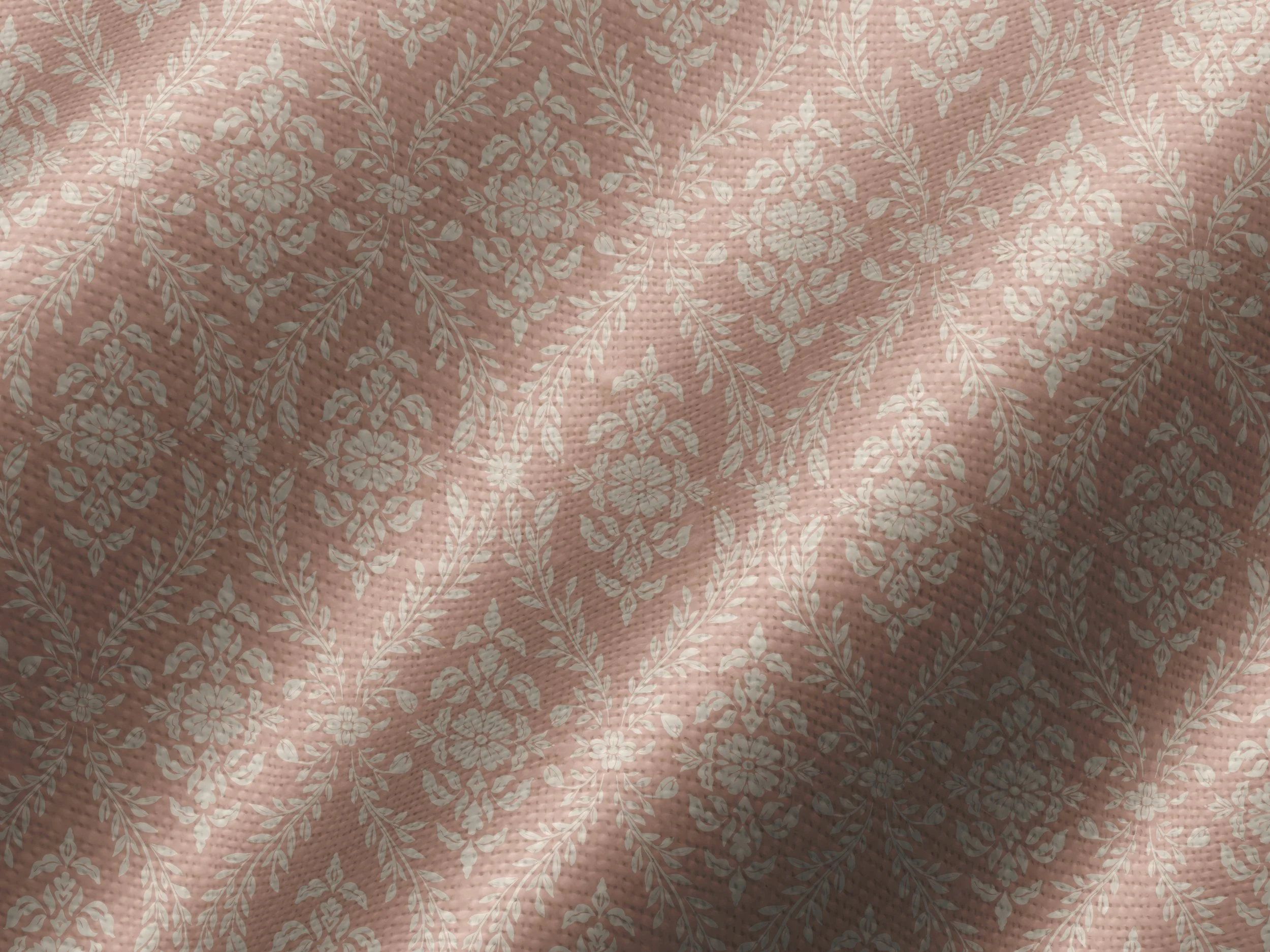 Close-up view of a deep rose colored textured fabric with a light pink floral damask pattern.