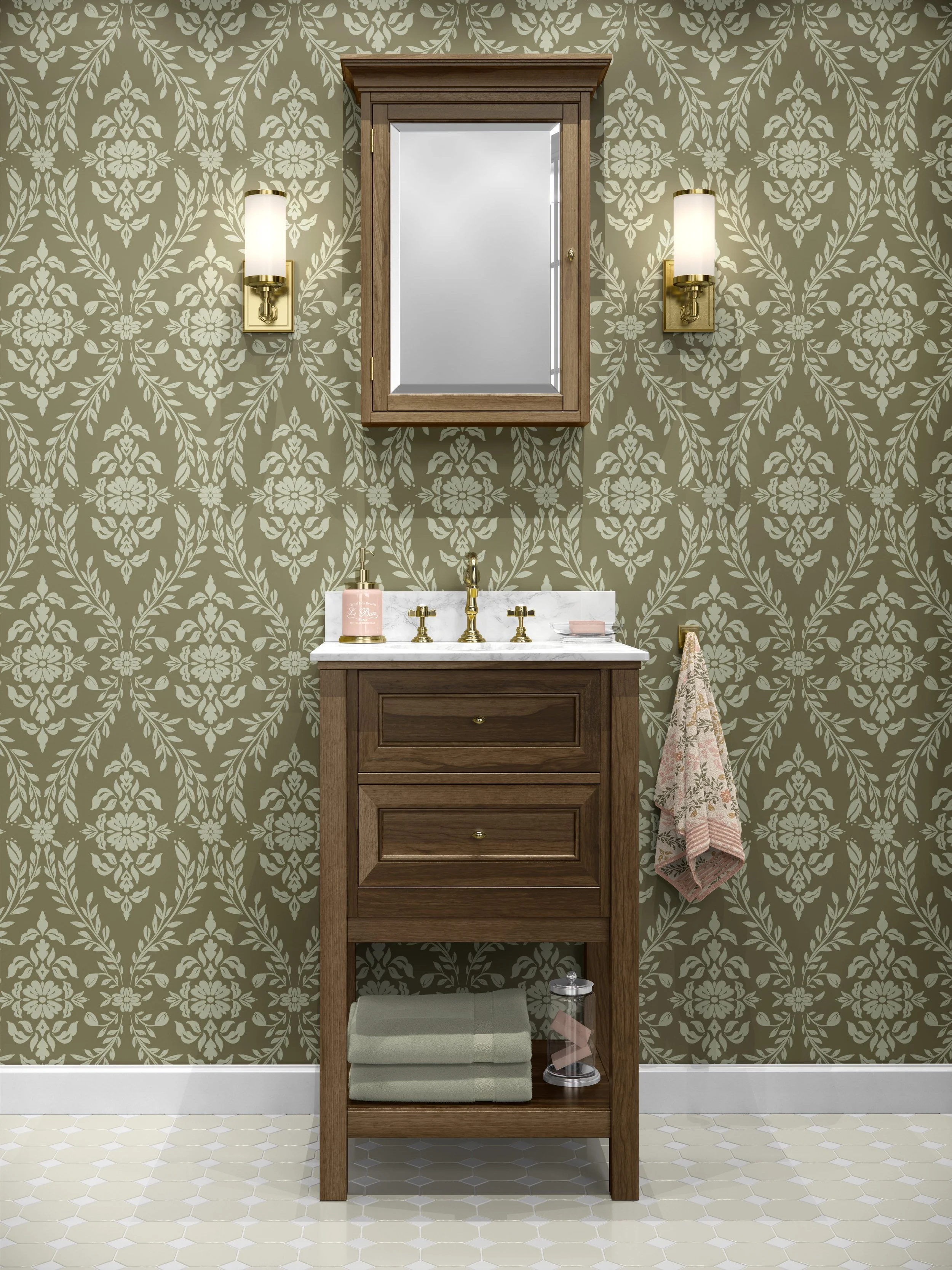 A wooden bathroom vanity with a white marble countertop and gold fixtures, set against a green floral wallpaper. A rectangular mirror with a wooden frame is centered above the vanity, flanked by two wall-mounted gold and white sconces. A pink soap di