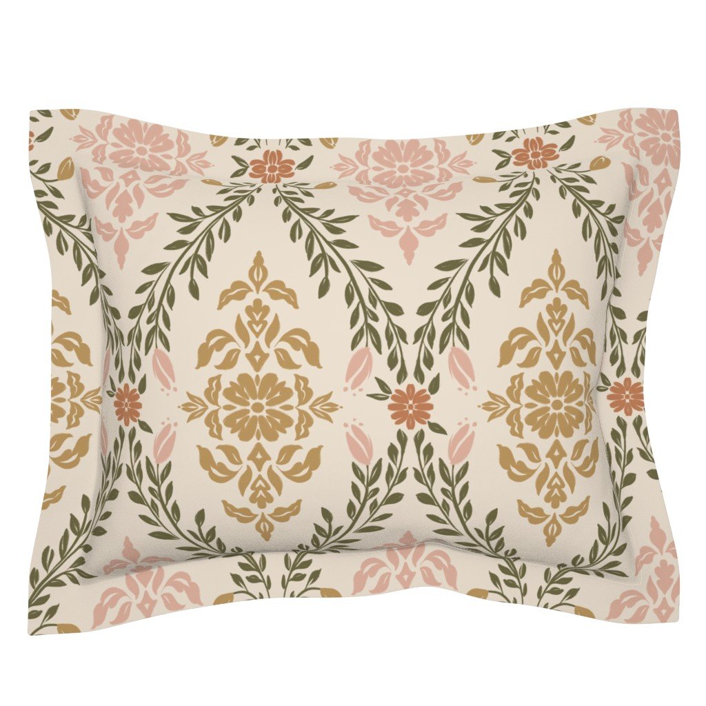Decorative pillow with a floral damask pattern in shades of pink, gold, terracotta, and green on an off-white background.