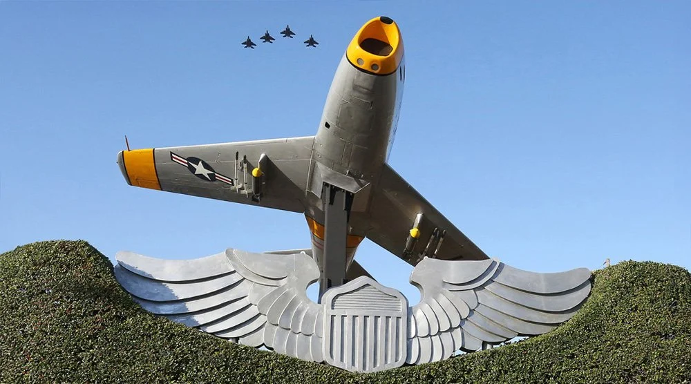 A large military aircraft flying in formation with four smaller planes in the background, positioned above a memorial with wings and an eagle emblem.