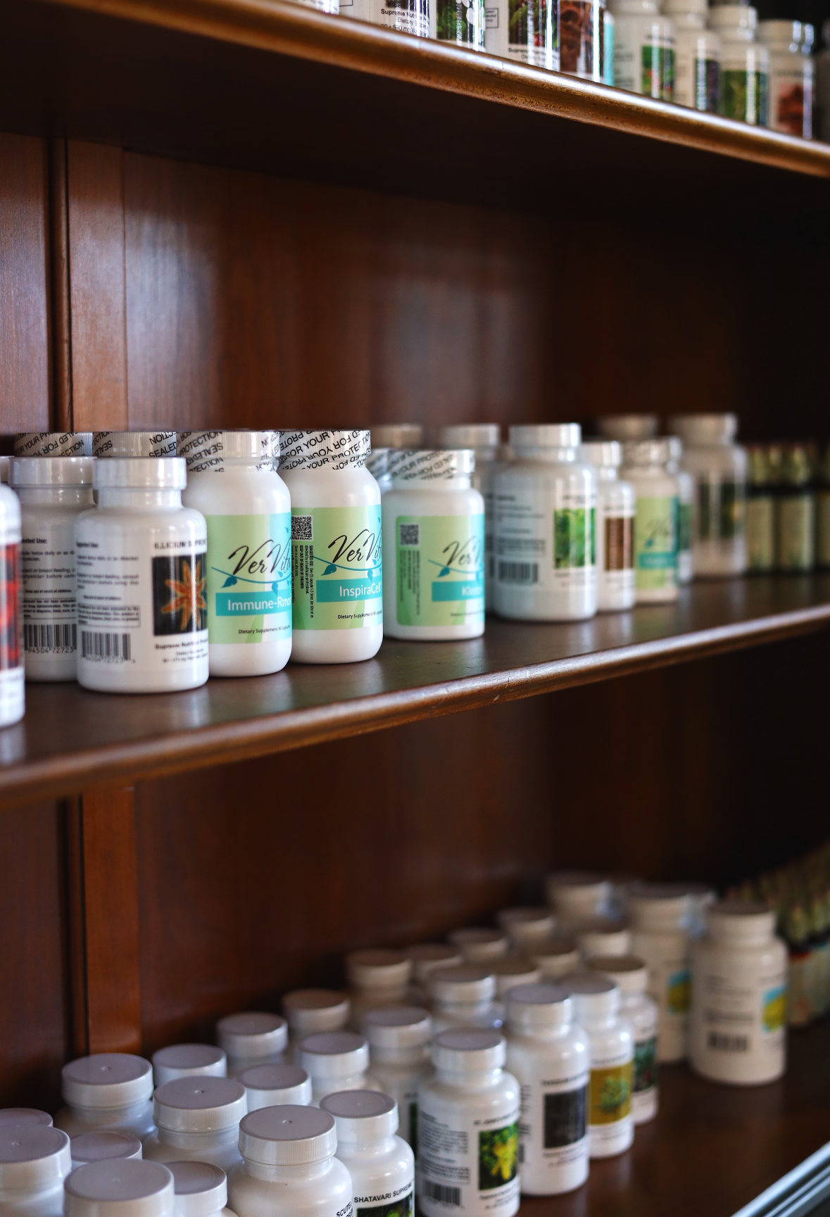 Shelves stocked with bottles of dietary supplements and vitamins.