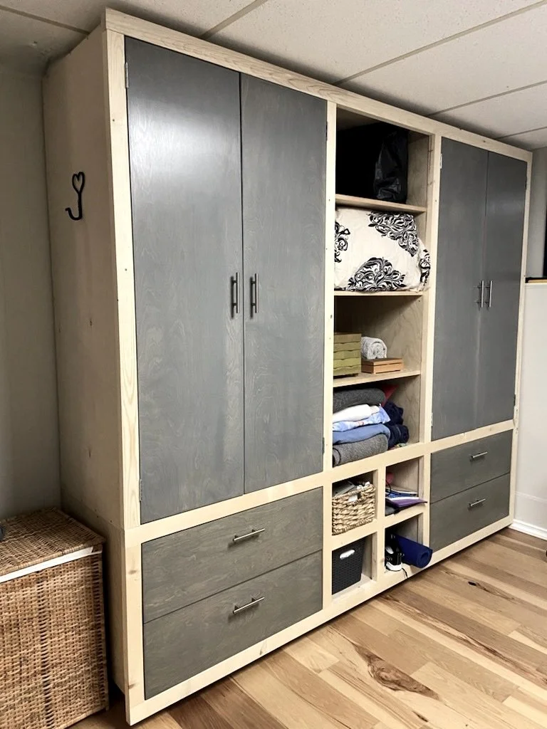 Custom built in wardrobe and shelving unit in master bedroom of two bedroom basement suite.  New water-resistent engineered hardwood flooring rated for basements. 