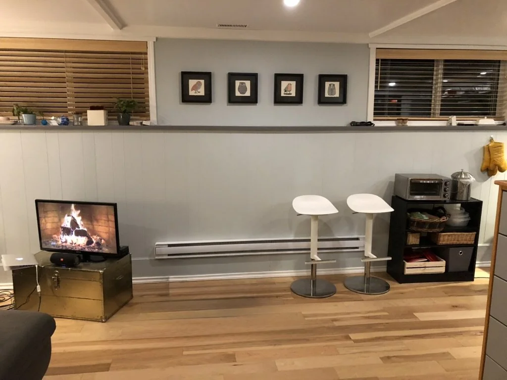 Basement Suite - Living Room: Replace existing T-Bar ceiling with coffered ceiling using beadboard paneling and custom moldings and LED ceiling lighting throughout basement suite common areas. Engineered flooring damp-rated throughout. 