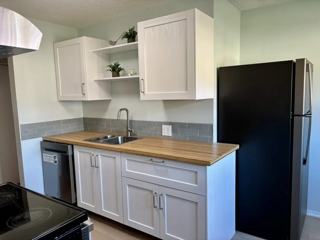 New prefab cabinets and counters with custom shelving units. Engineered hardwood flooring damp-rated for kitchen use.