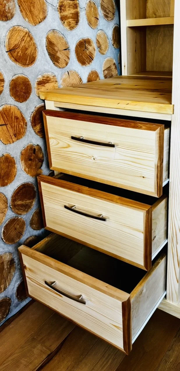 Custom built-in wardrobe, drawer and shelving unit utilizing a natural wax finish on mix of Canadian walnut, birch, yellow cedar and white pine.