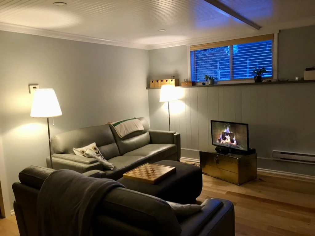 Basement Suite - Living Room: Replace existing T-Bar ceiling with coffered ceiling using beadboard paneling and custom moldings and LED ceiling lighting throughout basement suite common areas. Engineered flooring damp-rated throughout. 