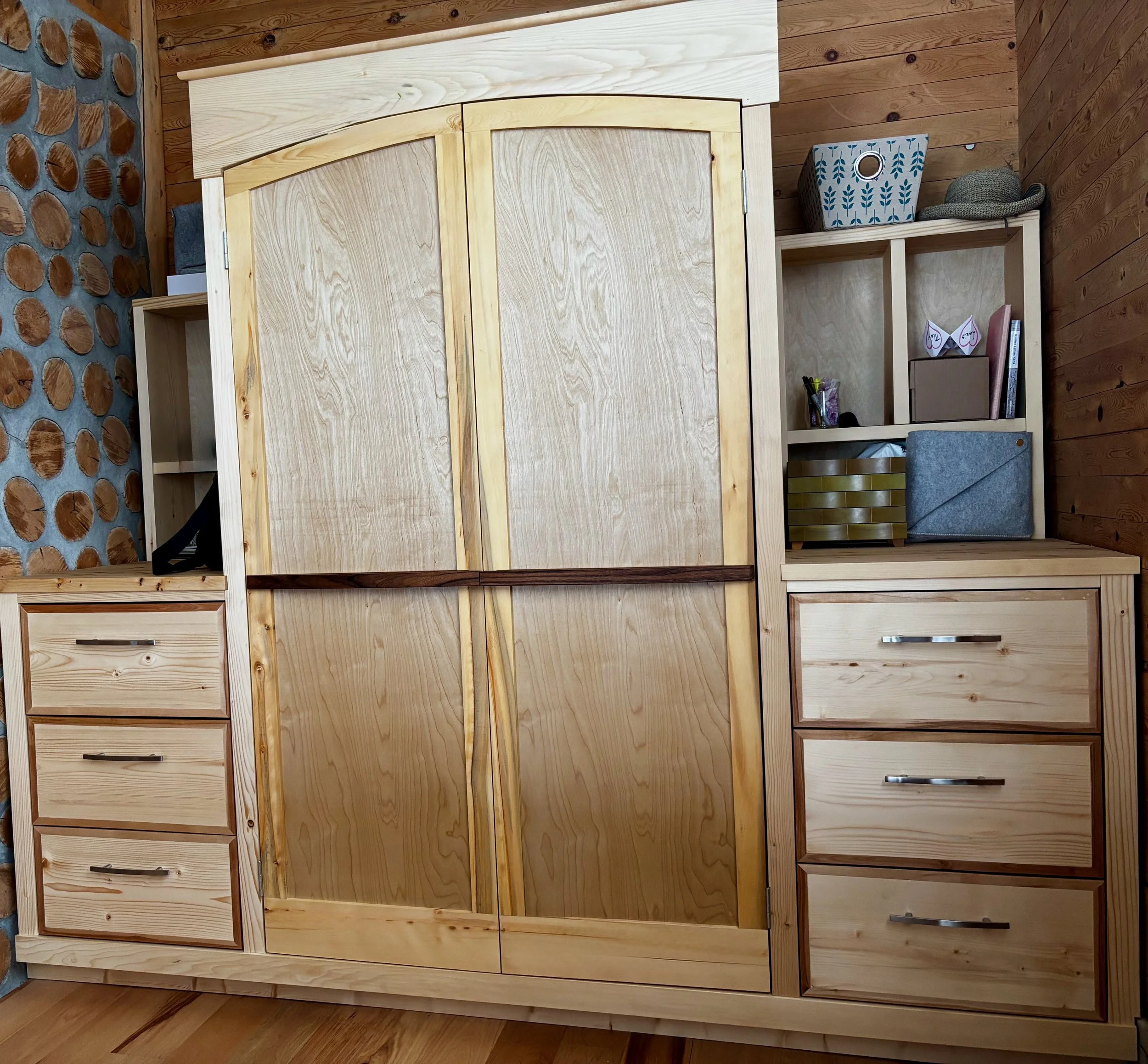 Custom built-in wardrobe, drawer and shelving unit utilizing a natural wax finish on mix of Canadian walnut, birch, yellow cedar and white pine.
