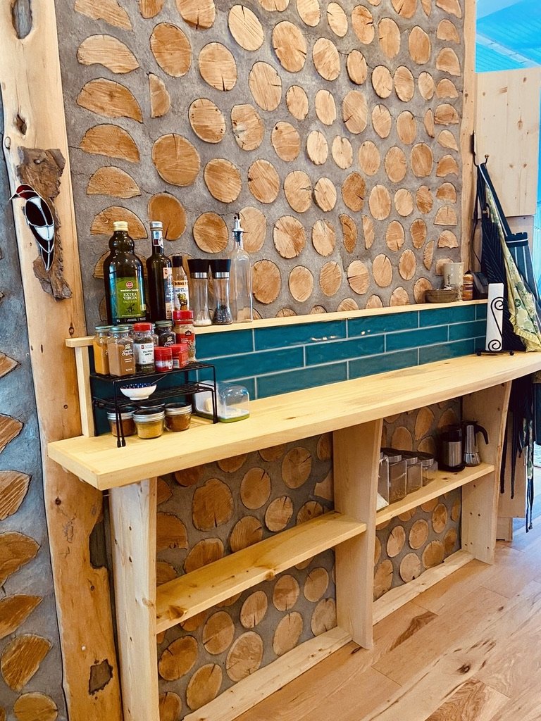 Custom yellow cedar cutting counter with shelving for jars and small appliances. Tile backsplash bordered in yellow cedar trip. Foodsafe citrus oil and beeswax finish. 