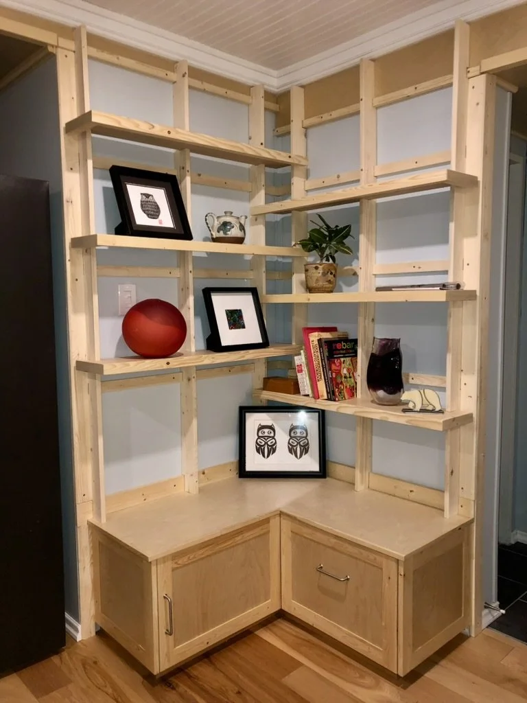 Custom wooden corner unit providing better use of limited wall space in a basement suite.