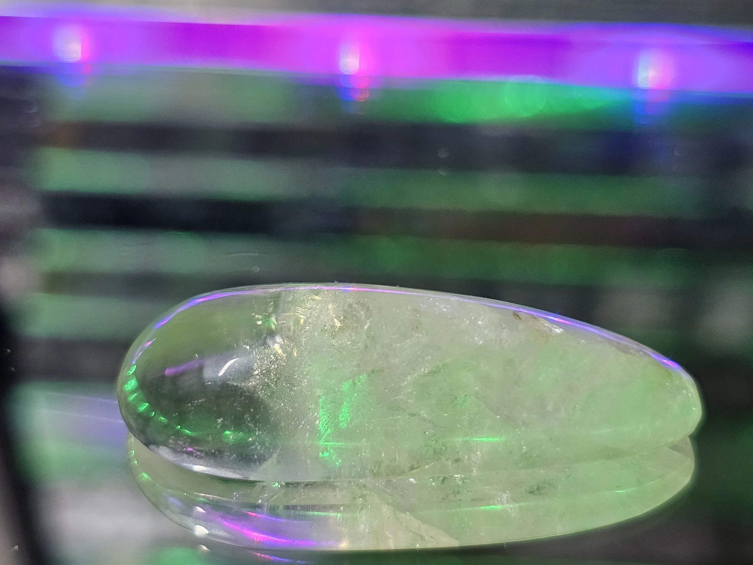 Clear and crackle quartz under neon lights with corregated metal background