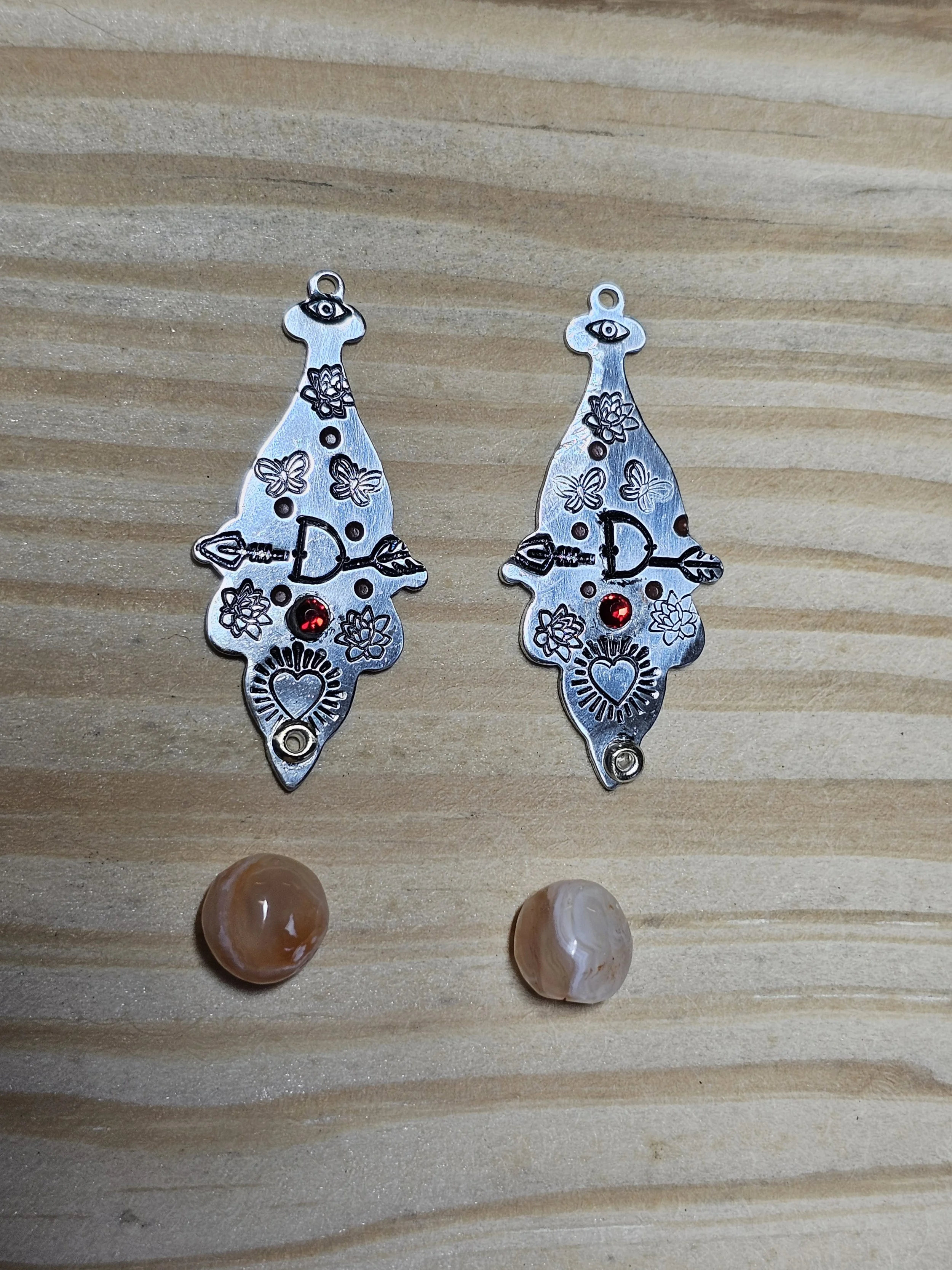 Aluminum stamping blanks and carnelian agates in the rough ready for creation. (Plan A)