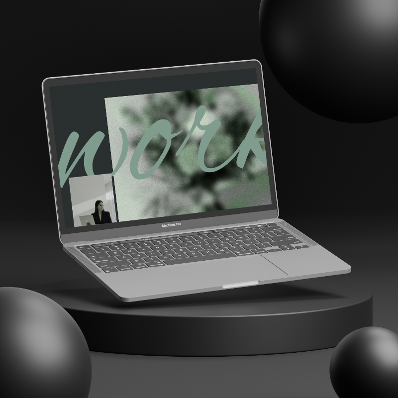 A MacBook Pro laptop on a black circular platform with black spheres around it, displaying a video call with a woman and a background with the word 'work' written in large, cursive font.