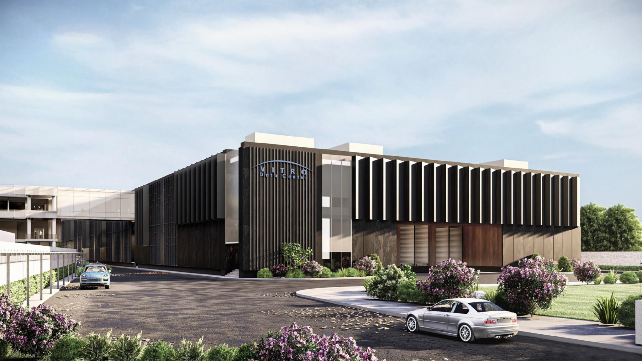 Modern red and black architectural sculpture with horizontal slats, viewed against a blue sky with clouds and sunlight.