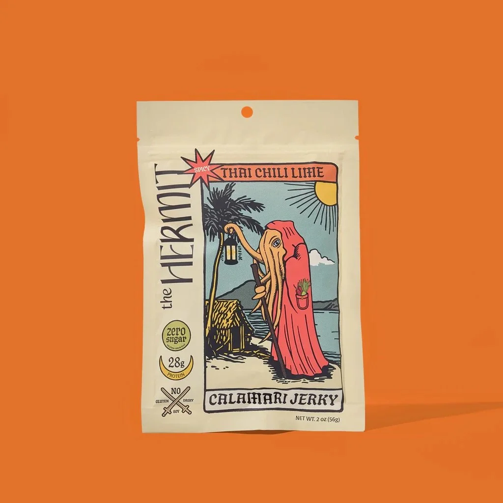 Packaging of Thai Chili Lime Calamari Jerky with a colorful illustration of a person, palm tree, and sun on a beach background, set against an orange surface.