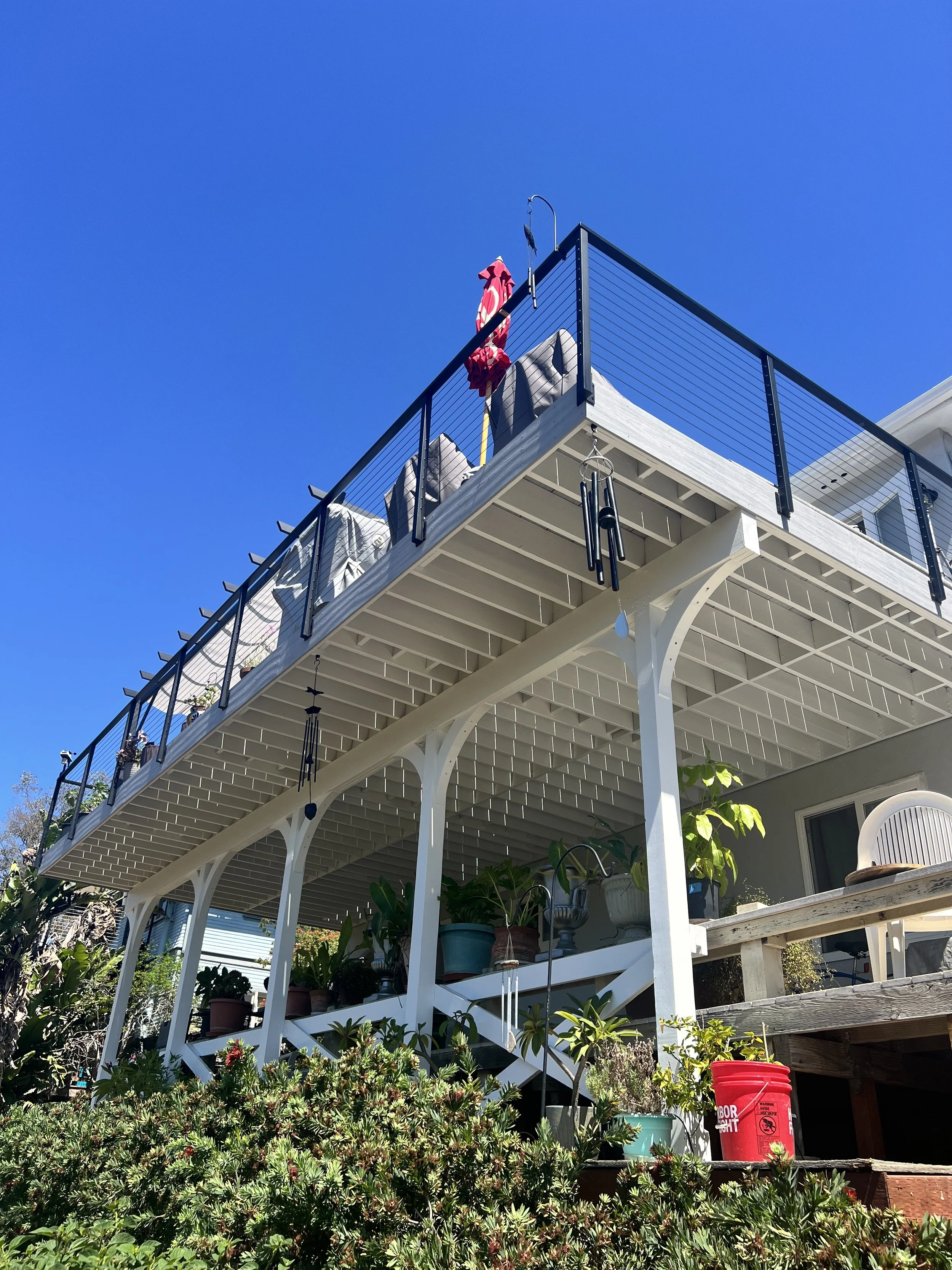 Second Story Deck Framed with Pressure Treated Lumber, CALI Bamboo Decking and Muzata Cable Railing system in South Park, San Diego.