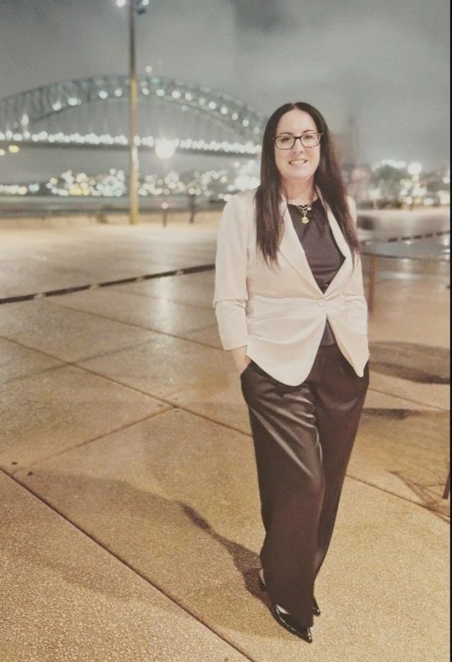 Gabrielle, trauma-informed mentor, standing in front of a bridge